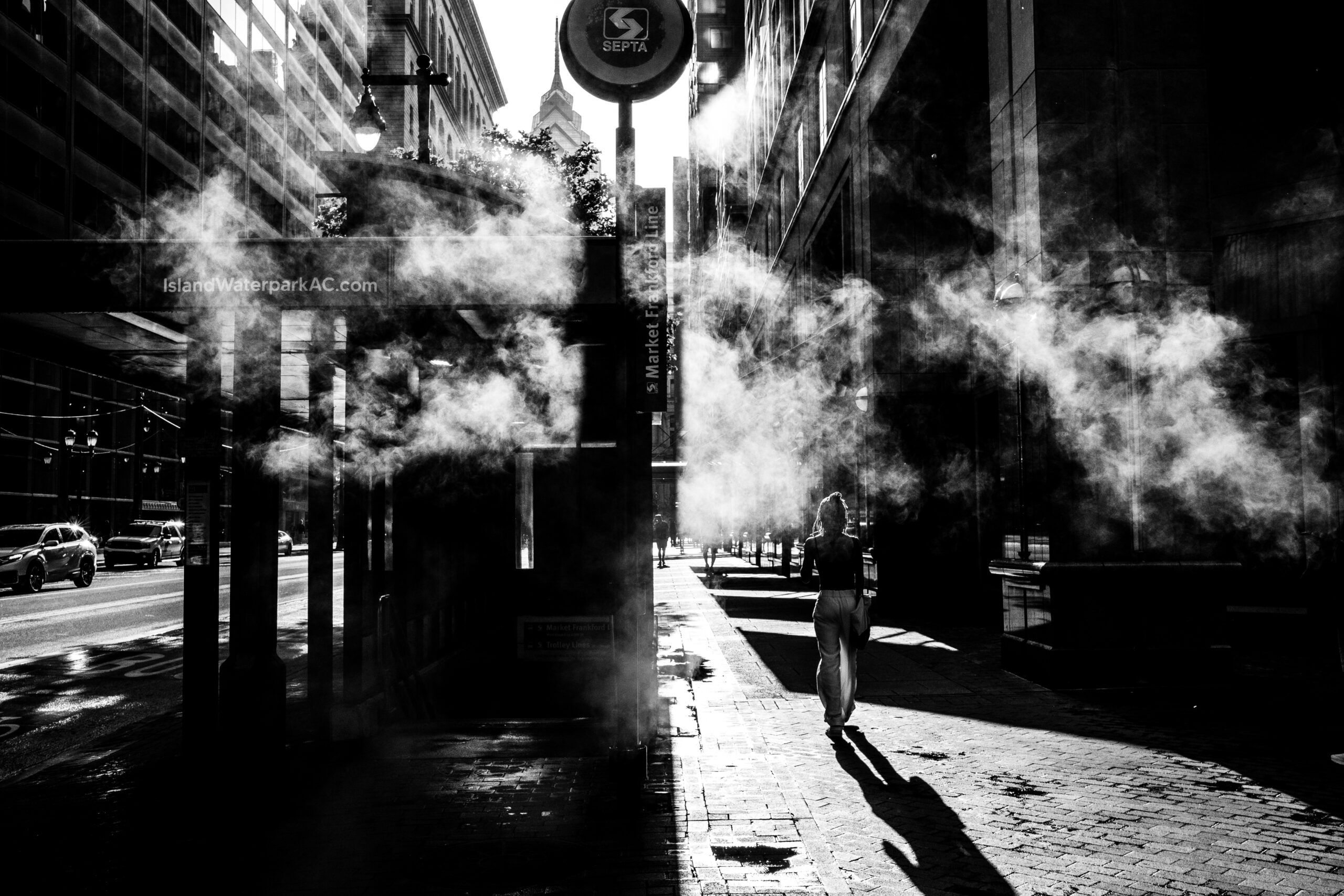 A Street Photograph of a Woman Walking in Sunlight